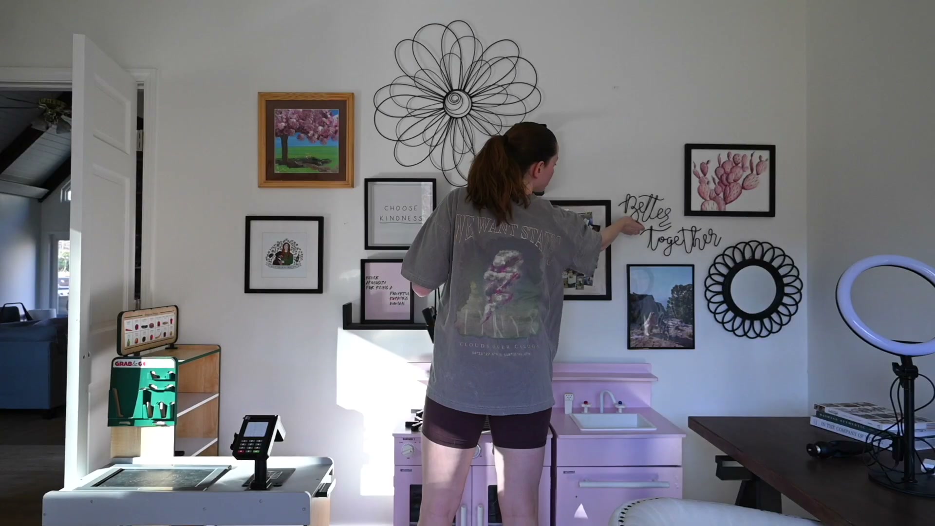 Tweaking gallery wall frame placement to get the spacing and balance right.