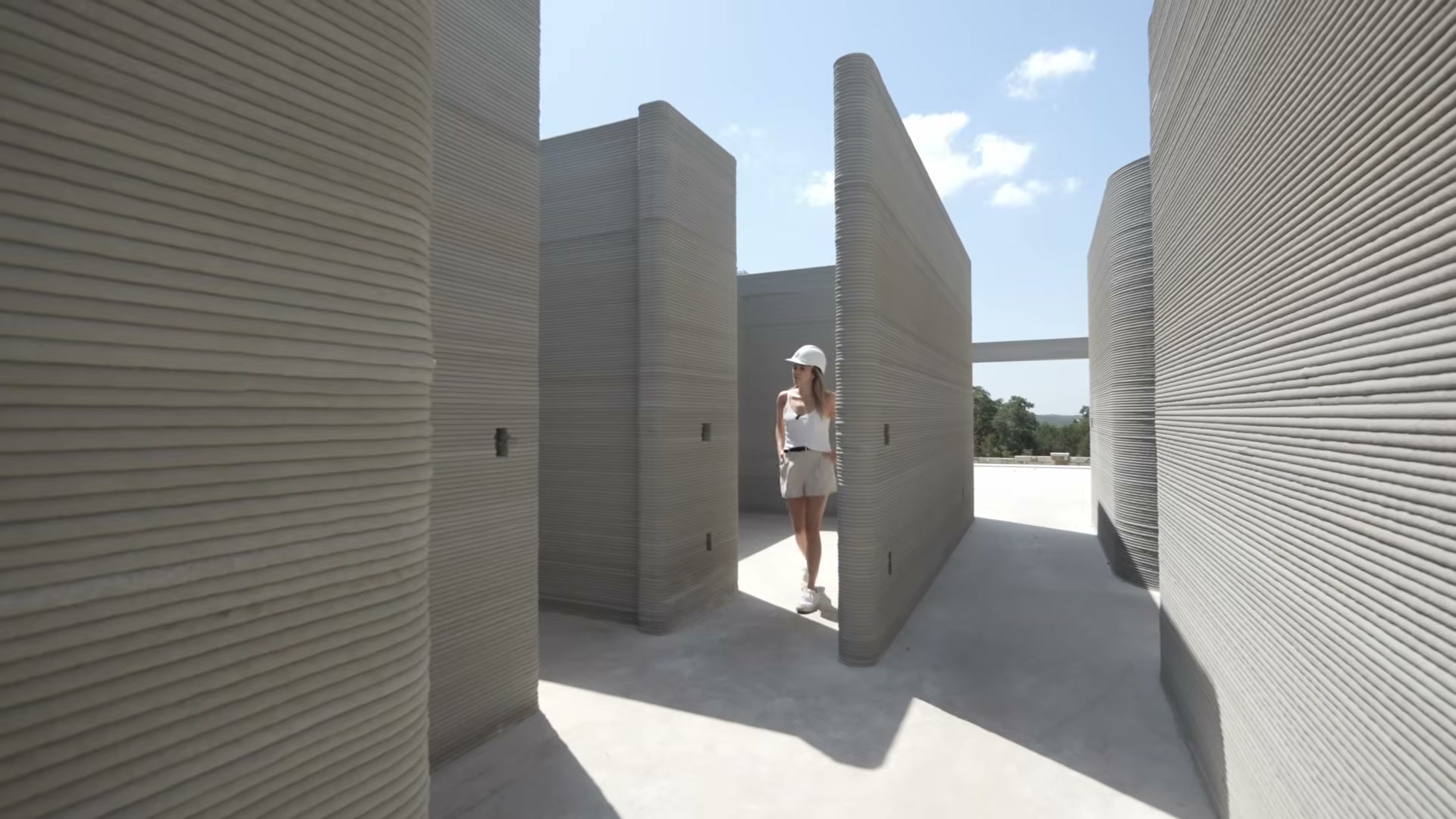 Walking through a completed 3D-printed concrete shell — structurally complete but far from move-in ready.