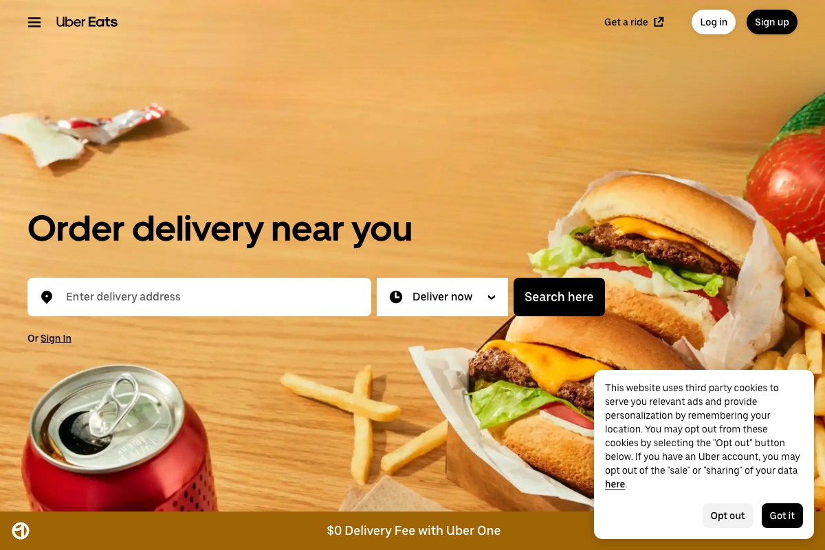 Uber Eats homepage showing '$0 Delivery Fee with Uber One' subscription promotion (ubereats.com, captured May 2026)